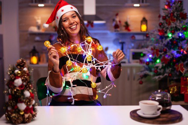 Caucasian Woman Decorating Christmas Tree With Lights 482257 18954